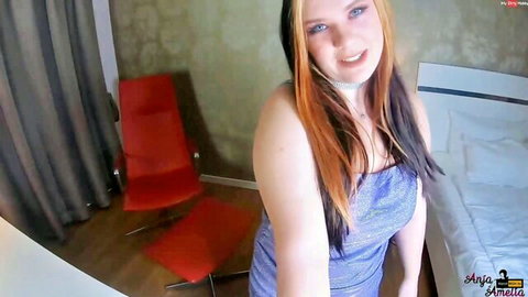 AnjaAmelia smiling in sparkly blue dress, big tits on display