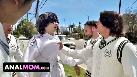 Group of men in white uniforms grab curvy brunette woman in school outfit outdoors