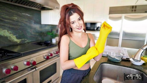 Vanessa Marie smiling in yellow rubber gloves for kitchen handjob scene