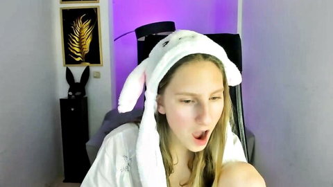 Sugar_plum_ blonde cam girl in white bunny ears hood, surprised open mouth, steamy solo show