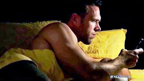 Markie More shirtless muscular man gaming intensely on couch