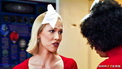 Blonde gymnast in red top with black curly-haired woman in intense Brazzers scene