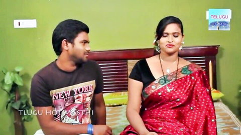 Seductive Indian aunty in red saree with young man on bed, Telugu hot scene