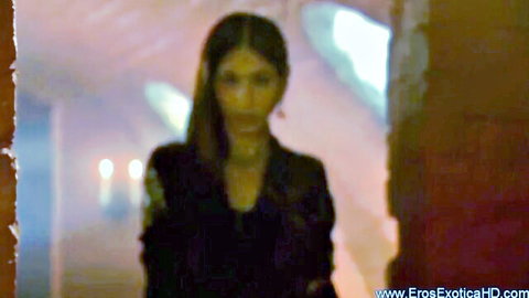 Indian woman in black dress in dimly lit tantra sexuality exploration