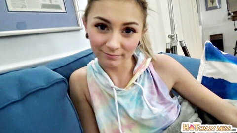 Petite blonde teen smiling cutely in tie-dye hoodie on couch POV