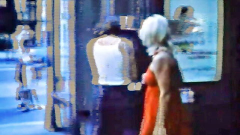 Vintage blonde woman in red dress, curvy figure in public tease scene