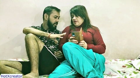 Desi couple watching phone in bedroom, teasing steamy orgy with wife