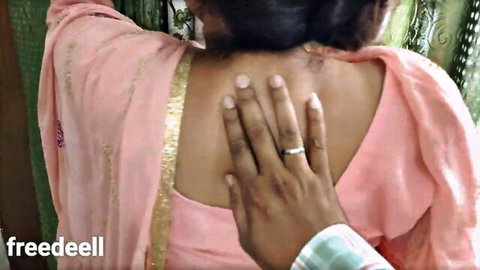 Indian woman in pink saree touched intimately on back by man