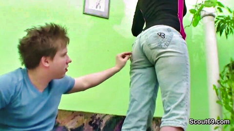 Young guy pulls at hot babe's tight jeans ass from behind teasing her pussy