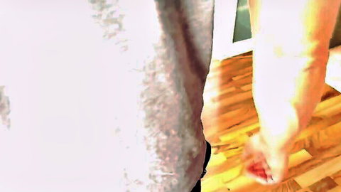 Woman's red-nailed hand gripping wooden floor intensely during rough sex