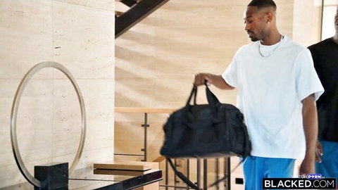 Two muscular black men carrying duffel bag in luxury lobby ready for BBC interracial action