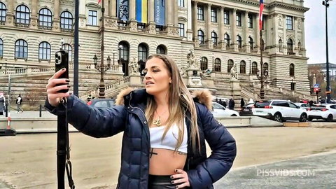 Blonde babe in crop top and leather pants takes sexy selfie outdoors at parliament building