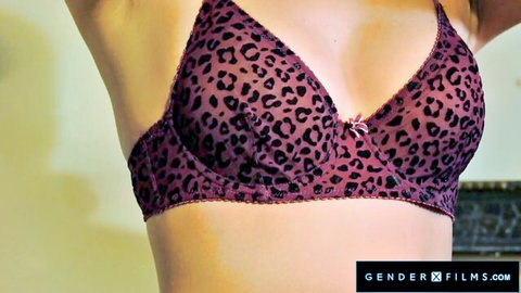Fair-skinned babe lifting arms in sheer purple leopard bra revealing perky medium tits
