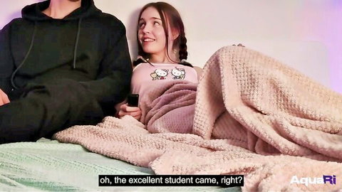 Naughty pigtail teen in Hello Kitty top smiles teasingly at guy on bed under pink blanket