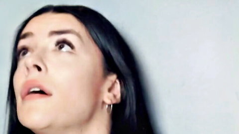 Intense brunette with long hair looks up moaning passionately during elevator blowjob