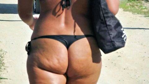 Thick BBW babe walks outdoors in tiny black thong bikini exposing huge cellulite ass cheeks