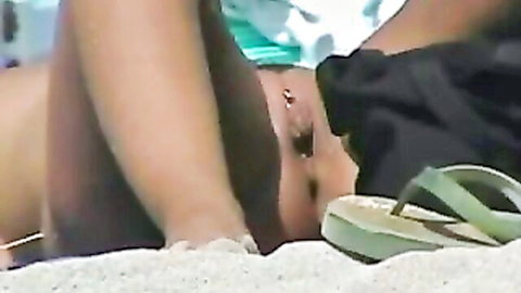 Stunning tan lines on nude beach beauty's shaved pussy caught on voyeur cam