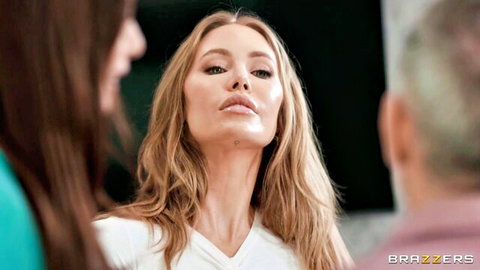 Nicole Aniston in white top, surrounded by colleagues in steamy office tease