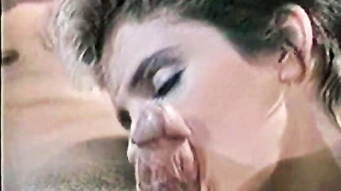 Vintage short-haired blonde performing intense blowjob in classic porn