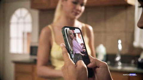 Cherry Kiss on steamy video call, blonde in tank top smiling in taboo scene