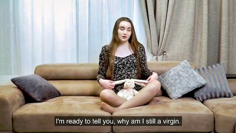 Margot Robbie lookalike virgin girl on couch with teddy bear