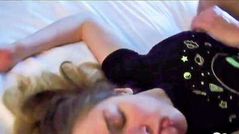 Blonde babe's bare ass exposed and grabbed by hand while lying face down on bed in space-themed t-shirt