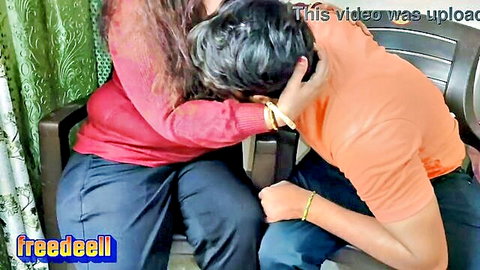 Indian teacher embraces young student intimately in classroom