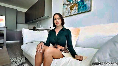 Tanned Latina MILF in tight green crop top and mini skirt sits seductively on couch teasing