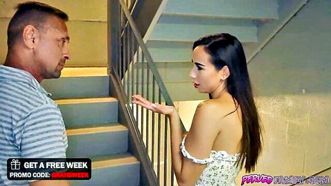 Curvy brunette stepdaughter flirts with DILF stepdad on stairs in low-cut floral top