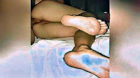 Blurry close-up of Mexican woman's bare feet and legs during amateur anal sex
