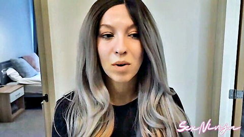 Sexy MILF with long gray hair in black top, teasing gaze from SexNinja