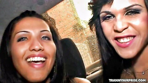 Smiling brunette trans woman and hot friend in car interior tease