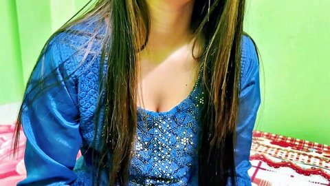 Sexy Indian Desi woman in embroidered blue dress with deep cleavage and long hair