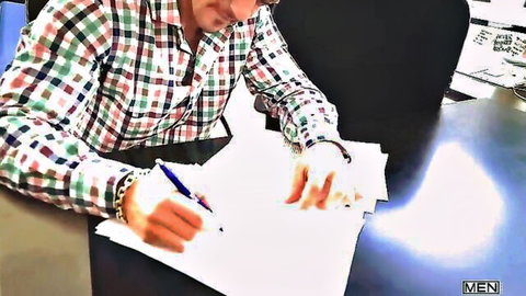 Tony Rivera in checkered shirt signing papers at office desk, teasing gay oral action