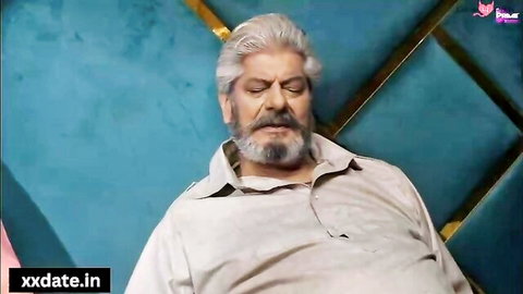 Mature Indian man with gray hair and beard reclining in shirt