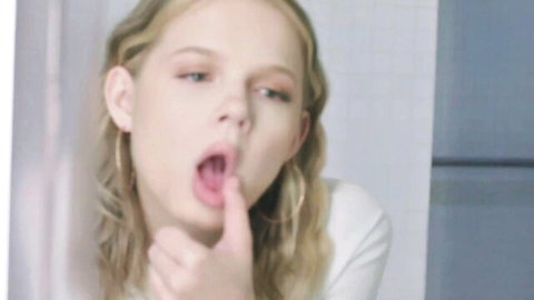 Petite blonde Coco Lovelock teases with open mouth and tongue