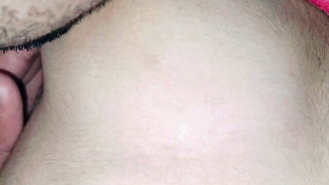 Close-up of Indian man's neck and chest in red cloth, intimate taboo scene