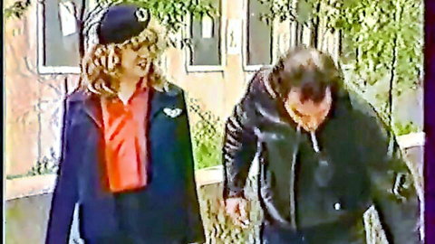 Blonde white babe in flight attendant uniform with leather-clad man, classic threesome tease