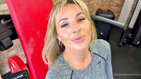 Blonde MILF Kayla Wild teasing with tongue out in tight gym top
