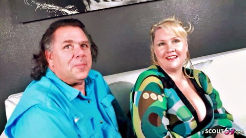 Blonde BBW wife in low-cut dress with cuckold husband watching