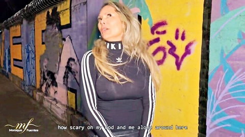 Blonde Colombian MILF in tight Adidas top poses scared against graffiti wall