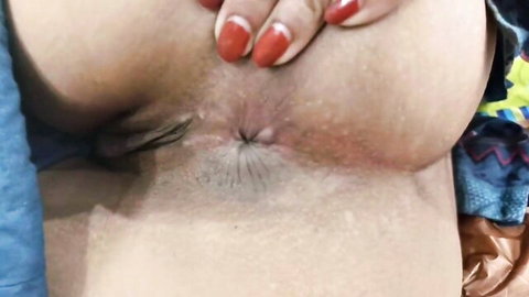 Indian woman spreads her wet creamy pussy lips with red nailed fingers revealing pink hole