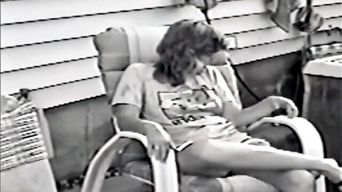 Blonde MILF in casual t-shirt and shorts relaxing outdoors