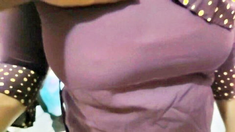Busty woman in purple dotted top showing deep cleavage, step sis tease