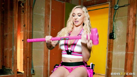 Blonde babe in sexy white harness and pink shorts holds pink sledgehammer