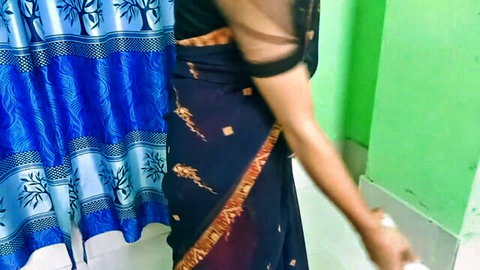 Desi maid in sheer black blouse and navy saree, teasing from side view