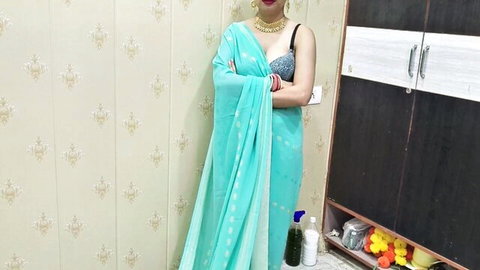 Indian bhabhi in tight teal saree with black bra visible, standing seductively
