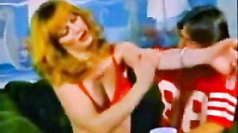 Skin Creme in red low-cut top embracing football player, vintage porn thumbnail