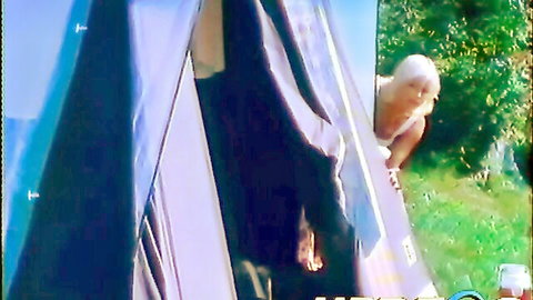 Gorgeous blonde babe peeking seductively from tent in classic retro porn