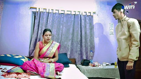 Indian nubile in pink saree on bed with stranger in kurta, teasing setup